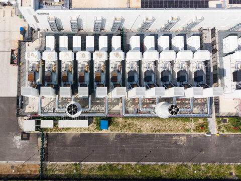 Aerial view of Vantage Data Centre - MXP1 showing rows of cooling units and industrial infrastructure at the facility in Melegnano, Lombardia, Italy.