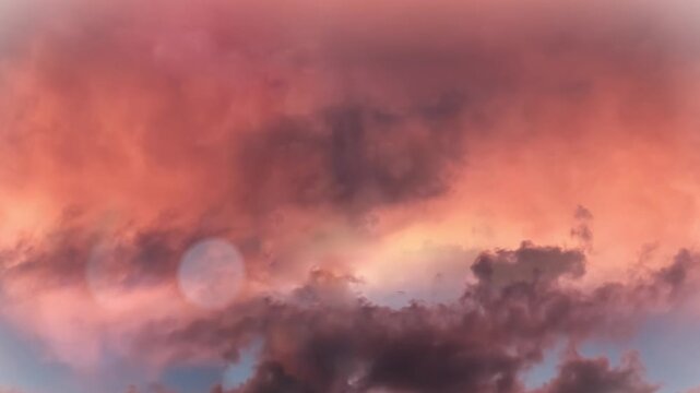 Seamless 4K looping vertical movement through glowing sunset clouds with vivid orange and pink colors. Perfect for cinematic backgrounds inspirational visuals and video editing.