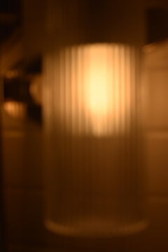 A dreamy view of a golden yellow light on the wall.