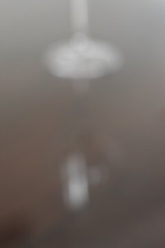 A dreamy view of a simple lamp hanging on a wall.