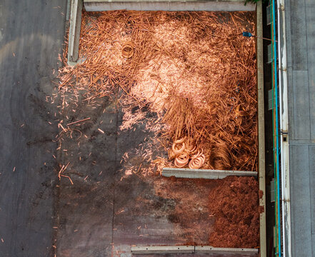 Aerial view of copper scrap and metal shavings stored in a concrete bay at the Serravalle Logistic area in Serravalle Scrivia, Piedmont, Italy.