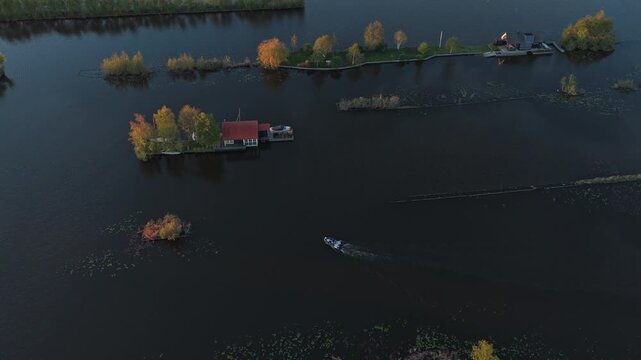 Aerial view of boat sailing on a dutch lake at sunset