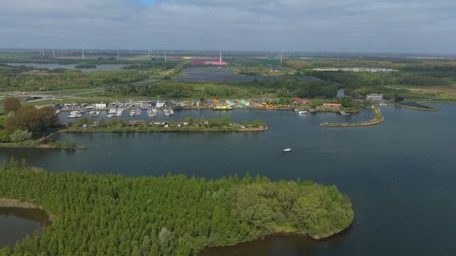 Veluwemeer lake aerial view revealing marina and wind turbines
