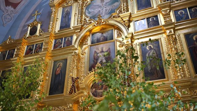 Orthodox iconostasis with gold ornamentation and religious icons, celebrating Christian faith