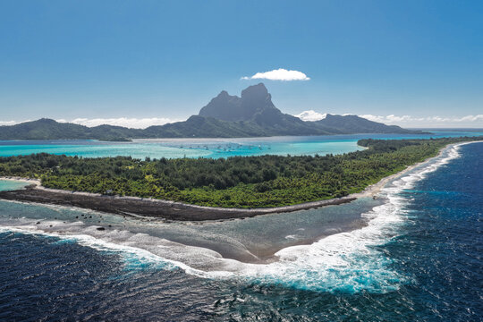 Aerial view of Mount Otemanu rising above the turquoise lagoon and lush tropical vegetation of Bora-Bora, Leeward Islands, French Polynesia.