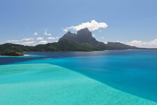 Aerial view of Mount Otemanu rising above the turquoise lagoon and lush tropical landscape in Bora-Bora, Leeward Islands, French Polynesia.