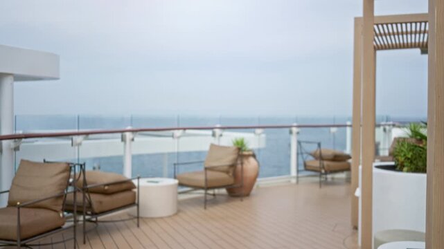 Cruise deck with blurred bokeh sea view and lounge chairs in shallow focus background outdoor; background backplate template calm.