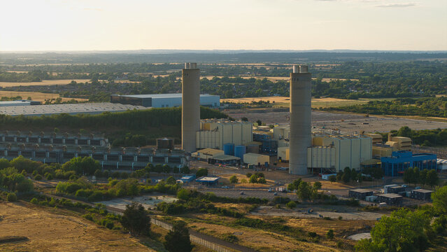 Aerial view of Didcot Power Station with its iconic tall chimneys and industrial buildings set against the surrounding landscape in Didcot, England, United Kingdom.