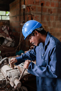 Worker using a large metal vice