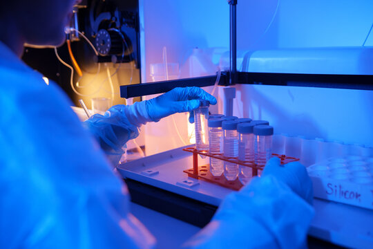 Laboratory technician conducting tests with test tubes in a chemistry lab environment