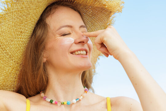 Woman Applying SPF Face Cream For Summer Sun Protection