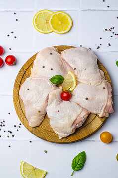 raw chicken legs, raw chicken thighs on a white background, raw chicken thighs on a wooden board