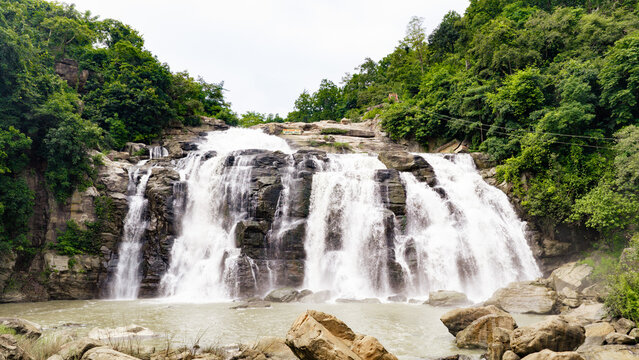 Aerial view of Jonha Falls cascading over rocky cliffs surrounded by lush green forest in Guridih, Jharkhand, India.