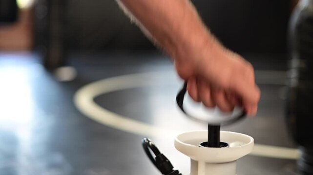 Manual sprayer pumping and spraying gym cleaning mats, gym hygiene, cleaning equipment action