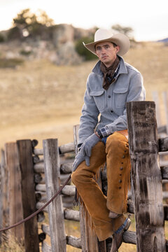Wyoming Cowboy sitting on fence Ranch scenic