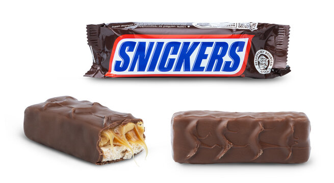 KYIV, UKRAINE - April 01, 2026 - Chocolate snickers bar in the package isolated on white. Broken chocolate bar. Unwrapped snickers chocolate bar.