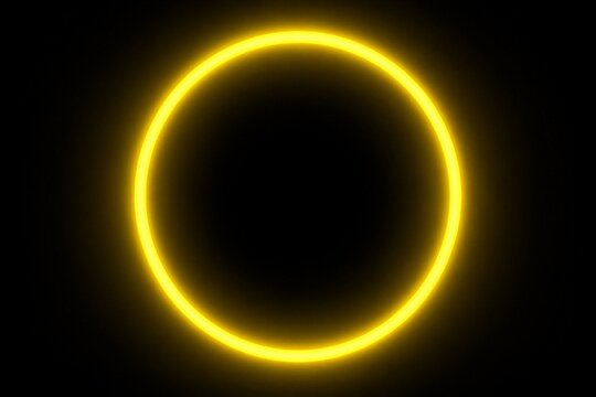 Glowing yellow ring illuminated against dark black background