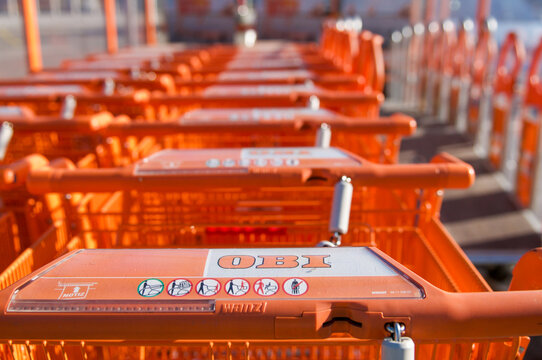 OBI orange shopping carts rows in selective focus outside hardware store