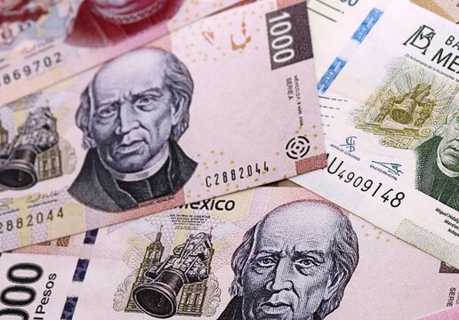 Mexican peso money bills pile on table. Mexico banknotes of MXN currency close up.