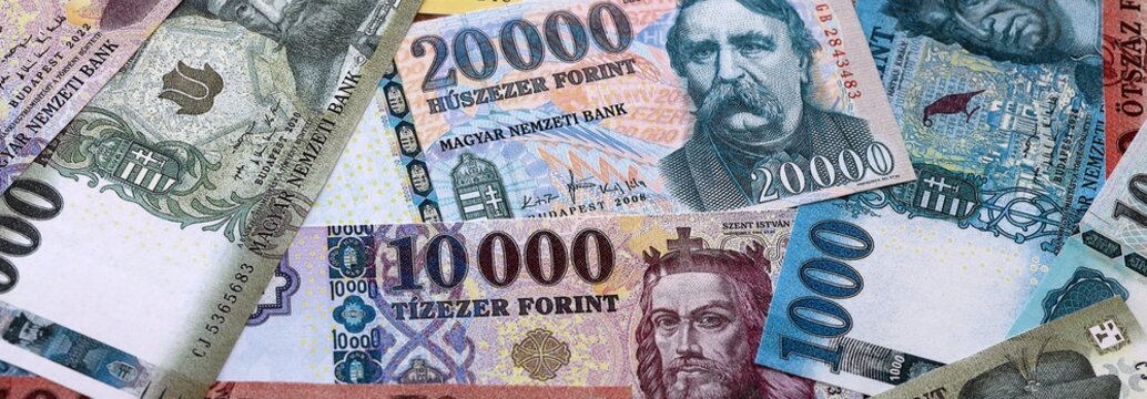 Hungarian forint money bills pile on table. Hungary banknotes of HUF currency close up.