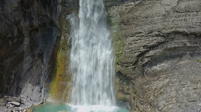 Powerful Sorrosal Waterfall flowing over layered rock cliffs