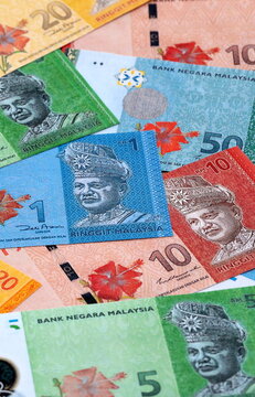 Malaysian ringgit money bills pile on table. Malaysia banknotes of MYR currency close up.