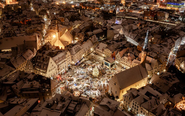 Aerial night View of Tallinn with the Town Hall Square in winter, roofs with snow, Christmas mood © Roxana