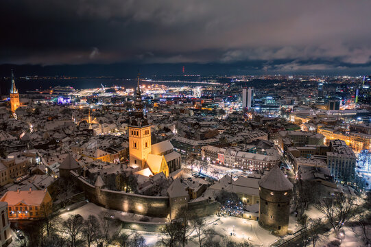 Aerial night View of Tallinn in winter, roofs are covered with snow, Christmas mood