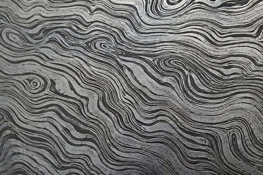 abstract monochrome wavy pattern background mimicking damascus steel and wood grain texture
