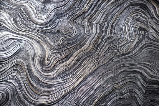 abstract monochrome wavy pattern background mimicking damascus steel and wood grain texture