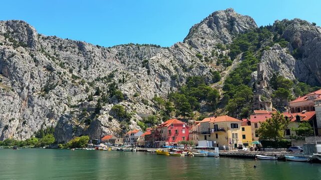Scenic view of Omis town with colorful houses and boats on the Cetina River in Croatia