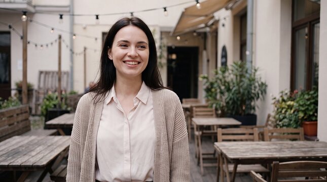 Beautiful Young Woman Smiling Outside a Cafe Representing Joy and Success in Everyday Life Moments