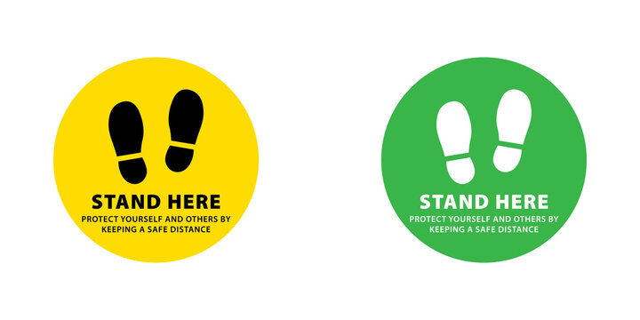 Stand here social distancing floor sticker signs with footprints in yellow and green circular shapes