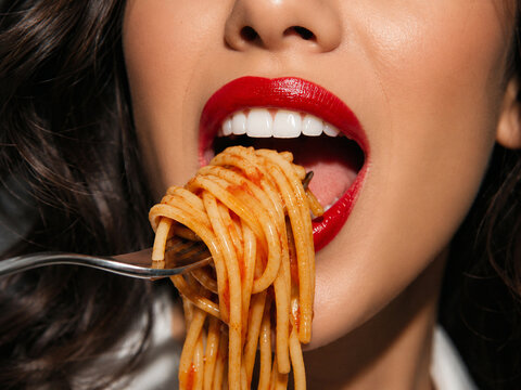 Woman red lipstick eating spaghetti pasta on fork food photography