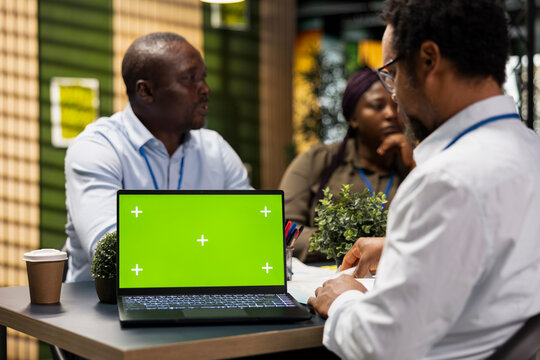 Laptop with an isolated screen provides a replaceable display for an engineering team automating repetitive tasks and using code to accelerate feature implementation during office collaboration.