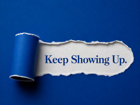 Torn paper revealing the message keep showing up on a vibrant blue background