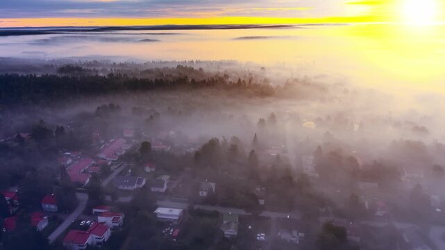 Early morning in a city home suburb area with mist and yellow sun light, drone footage. 