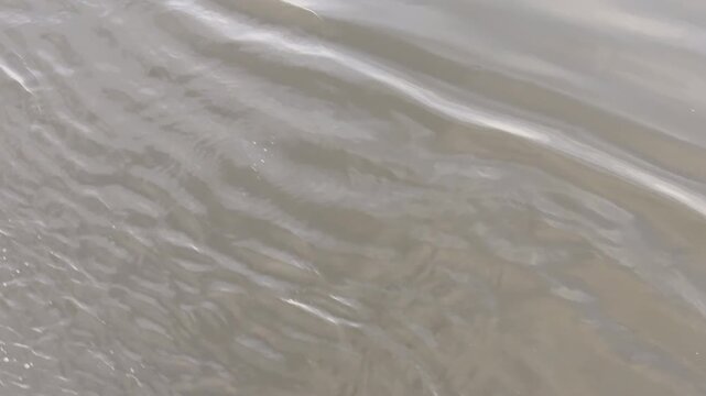 Slow motion water rippling creates textured background element