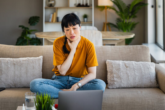 Woman consulting doctor online at home for sore throat and throat pain symptoms