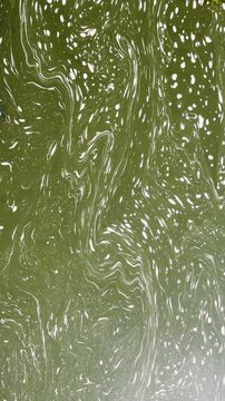 Slimy swirls in river current creates ethereal background element