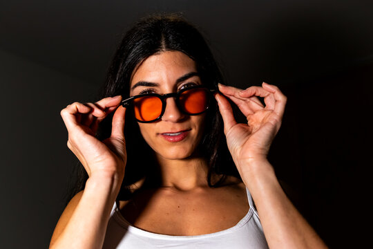 Woman wearing orange blue light blocking glasses for eye protection