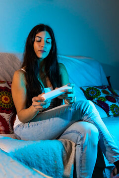 Woman wearing light protective goggles for home blue light skin therapy