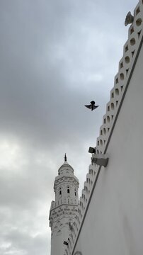 White minaret and exterior of historic Masjid Al Qiblatain in Medina.