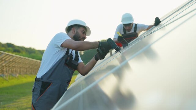 Indian solar panel installers mounting photovoltaic modules