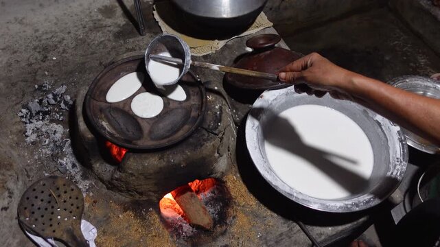 Rice powder are mixed with water and salt and poured into a terracotta mold, which is then cooked in a heated clay oven to make Chitai Pitha.