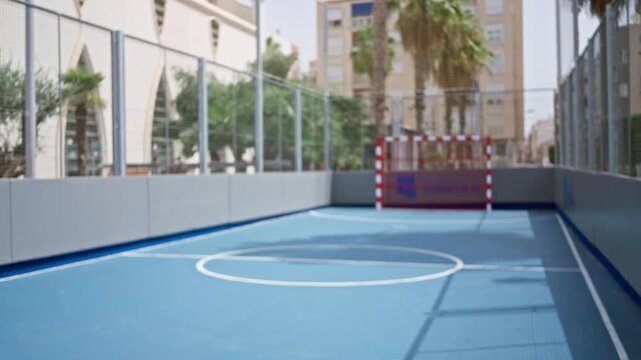 Blurred urban futsal court with soft bokeh and shallow focus outdoor; backplate copyspace template overlay.