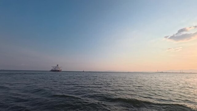Scenic marine landscape background footage featuring ship and harbor skyline for shipping industry and supply chain