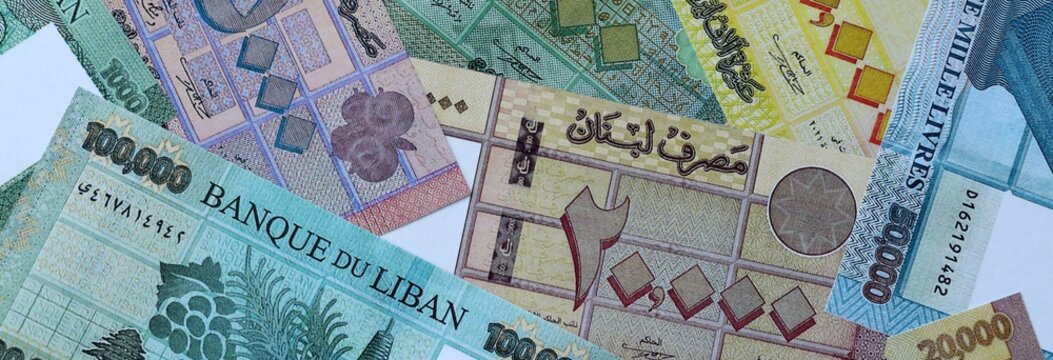 Lebanese pound money bills in pile on table. Lebanon LBP currency cash close up