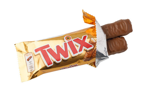 Twix chocolate bar unwrapping golden wrapper showing candy fingers on a transparent background