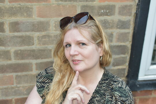 age 55 woman sitting in garden 